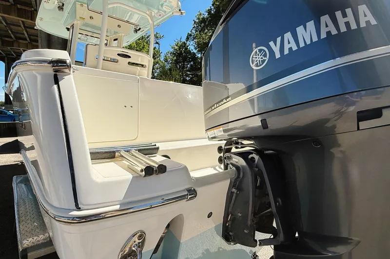 Slide: The Image of 2019 Pioneer 266 Pelagic boat with Yamaha outboard motor, docked under a bridge. - 8