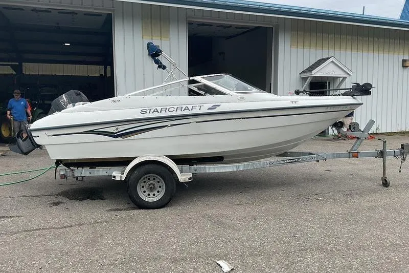 Slide: The Image of 1999 Starcraft 1809 Fish & Ski boat on trailer, parked outside a building. - 10