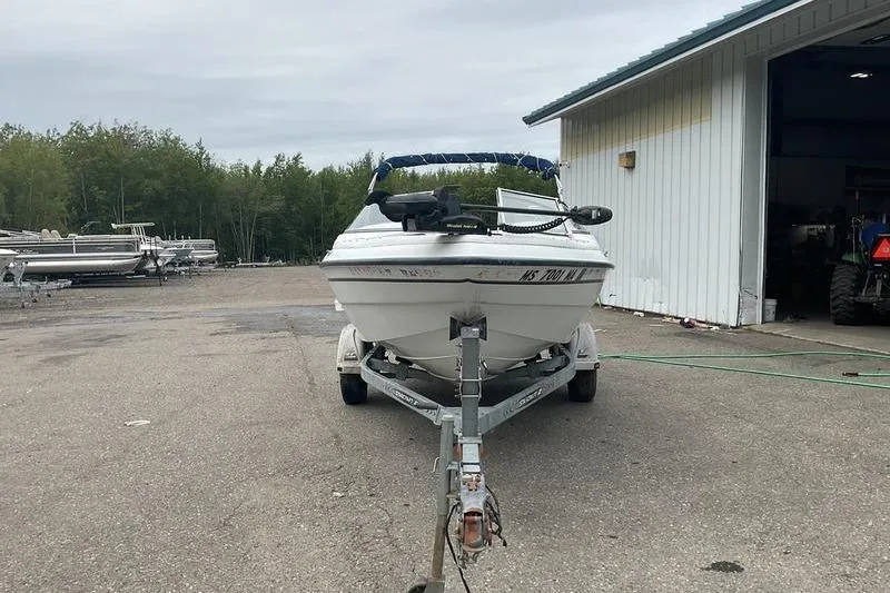 Slide: The Image of 1999 Starcraft 1809 Fish & Ski boat on trailer, parked near a building. - 4