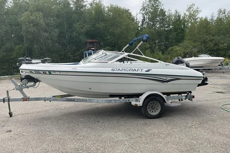 Slide: The Image of 1999 Starcraft 1809 Fish & Ski boat on trailer, parked outdoors. - 6