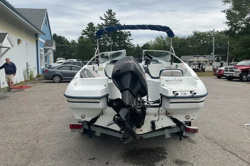 Slide: The Image of 1999 Starcraft 1809 Fish & Ski boat with outboard motor, parked outdoors. - 7