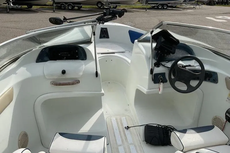 Slide: The Image of 1999 Starcraft 1809 Fish & Ski boat interior with steering wheel and seating. - 8