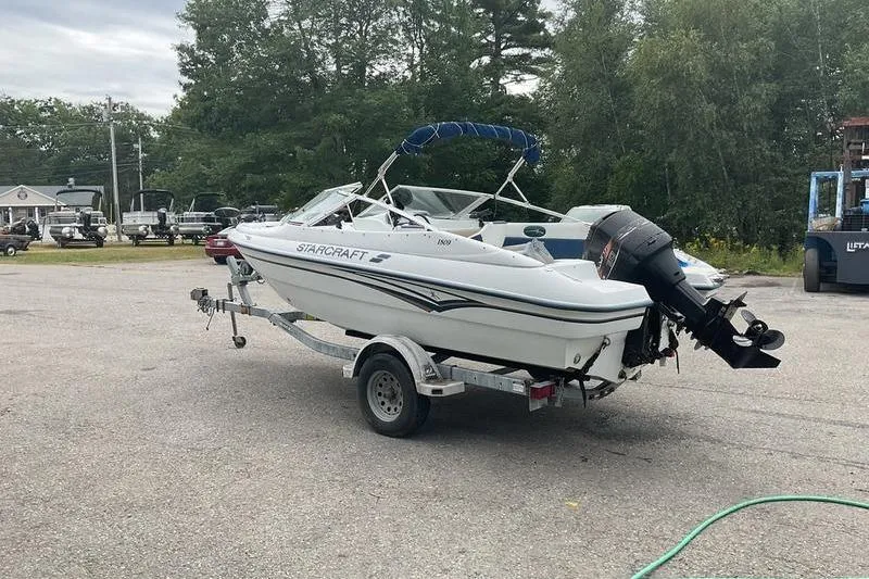 Slide: The Image of 1999 Starcraft 1809 Fish & Ski boat on trailer, parked outdoors. - 9
