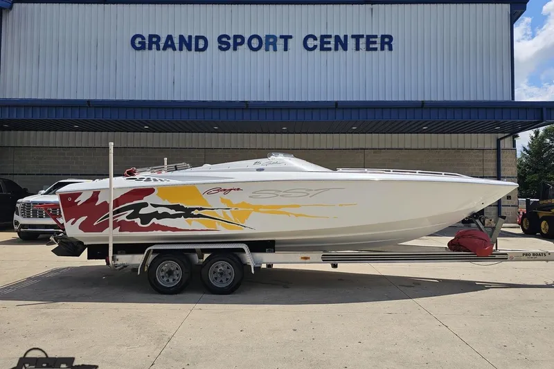Slide: The Image of 2002 Baja 25 Outlaw boat on trailer at Grand Sport Center. - 1