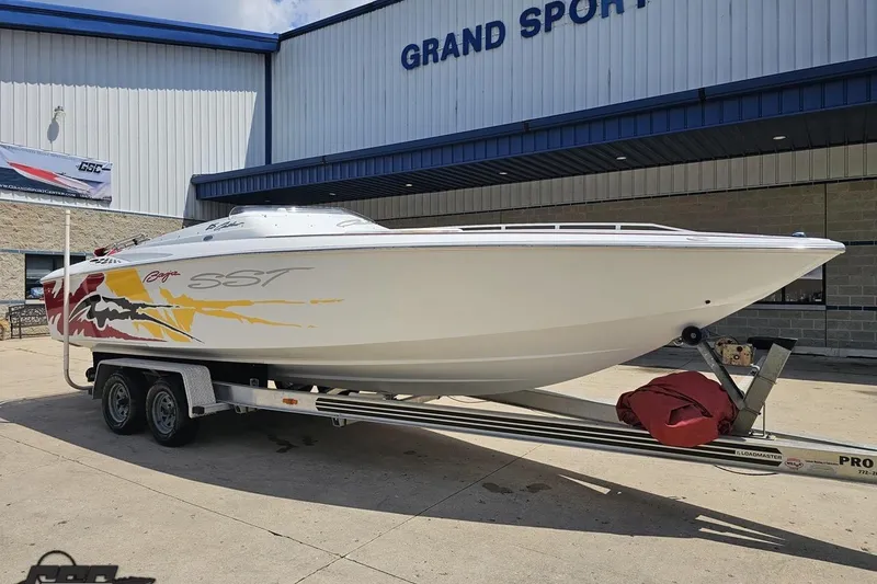 Slide: The Image of 2002 Baja 25 Outlaw boat on trailer outside Grand Sport Center. - 14