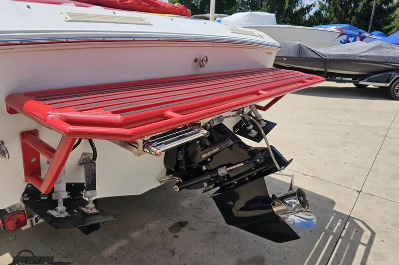 Slide: The Image of 2002 Baja 25 Outlaw boat with red swim platform and MerCruiser outdrive. - 29