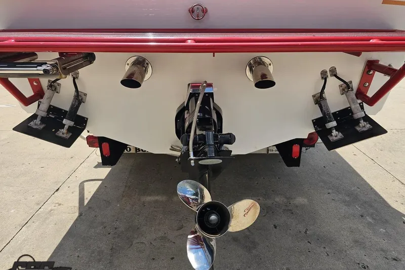 Slide: The Image of Rear view of a 2002 Baja 25 Outlaw boat with visible propeller and exhaust. - 32