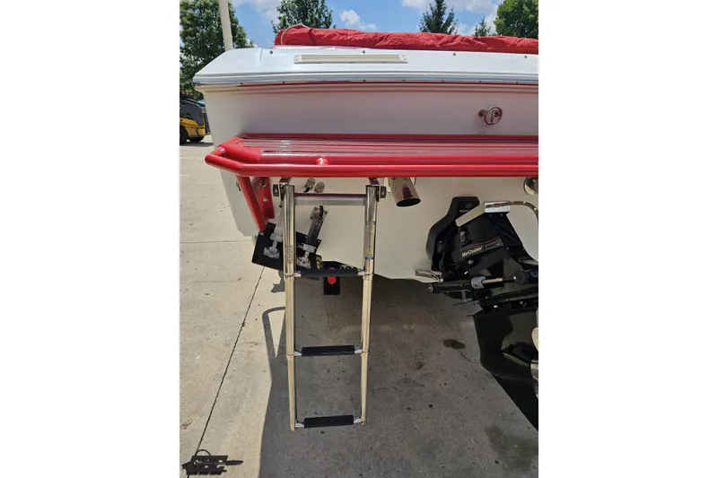 Slide: The Image of 2002 Baja 25 Outlaw boat rear view with ladder and red accents. - 36
