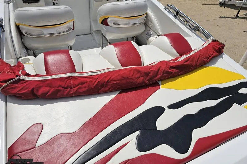 Slide: The Image of 2002 Baja 25 Outlaw boat interior with red, white, and yellow upholstery design. - 39
