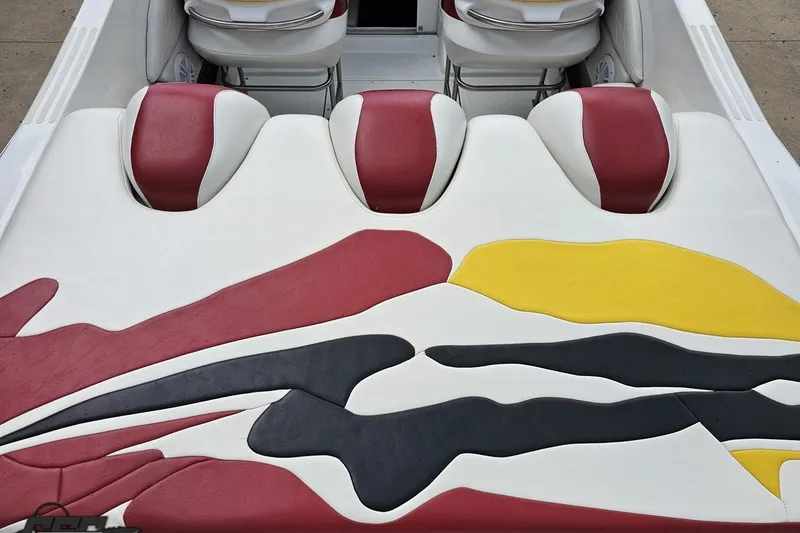Slide: The Image of 2002 Baja 25 Outlaw boat interior with colorful, abstract upholstery design. - 40