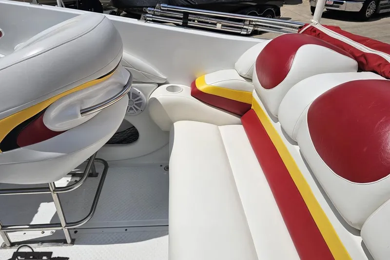 Slide: The Image of 2002 Baja 25 Outlaw boat interior with red, yellow, and white seating. - 45