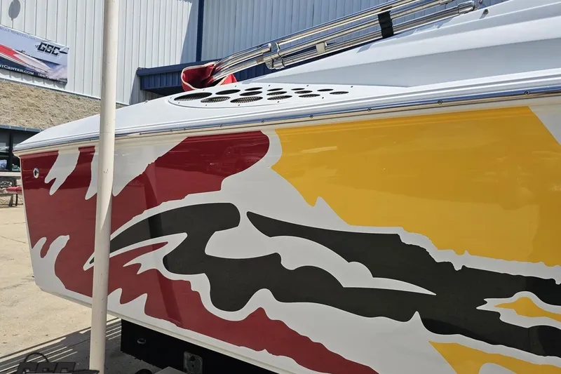 Slide: The Image of 2002 Baja 25 Outlaw boat with vibrant red, yellow, and black graphics. - 7