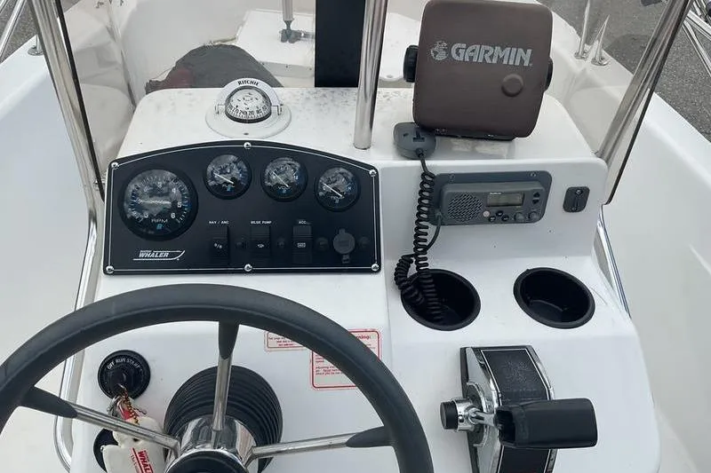 Slide: The Image of Boston Whaler 160 Dauntless 2000 boat dashboard with Garmin GPS and control panel. - 4