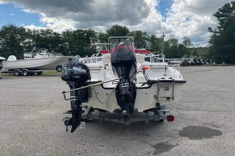 Slide: The Image of 2000 Boston Whaler 160 Dauntless boat with Mercury outboard motors in a parking lot. - 9