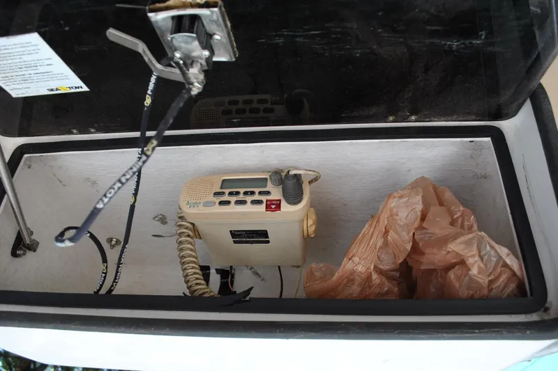 Slide: The Image of Storage compartment of a 2005 Cape Horn 22 Bay boat with a radio and plastic bag. - 19