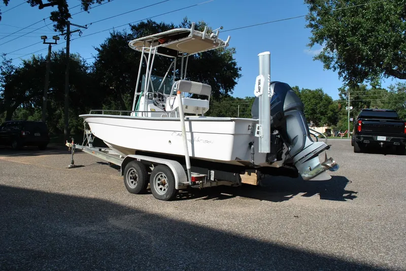 Slide: The Image of 2005 Cape Horn 22 Bay boat on trailer, parked outdoors under clear sky. - 10