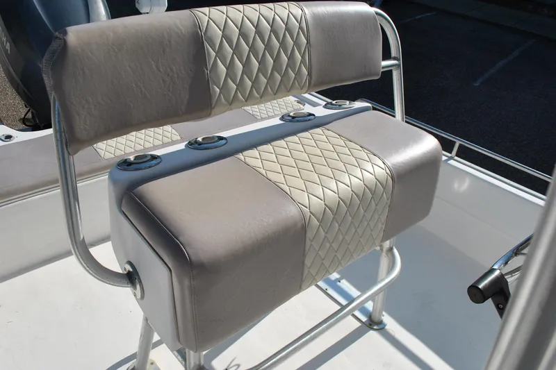 Slide: The Image of 2005 Cape Horn 22 Bay boat seat with diamond-patterned upholstery and rod holders. - 11