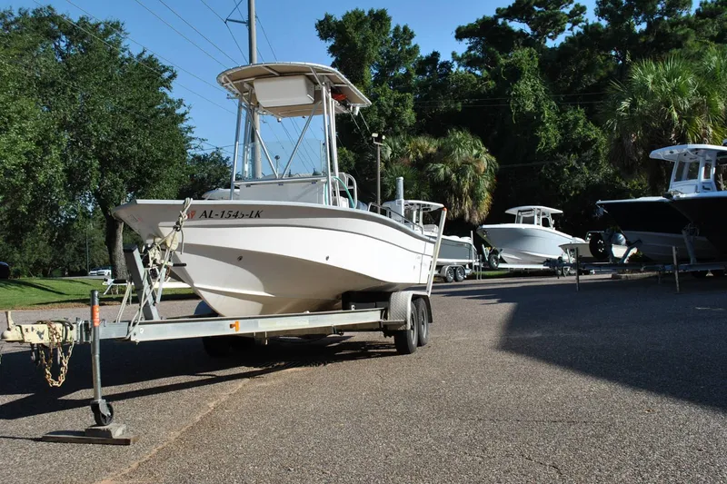Slide: The Image of 2005 Cape Horn 22 Bay boat on trailer, surrounded by trees and other boats. - 2