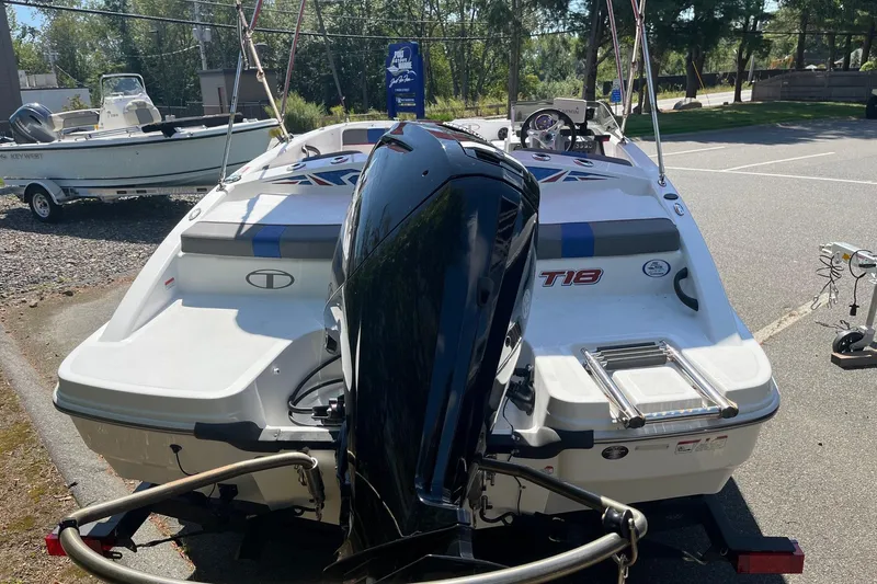 Slide: The Image of 2022 Tahoe T18 boat with outboard motor in a parking lot. - 11