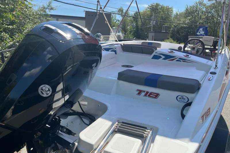 Slide: The Image of 2022 Tahoe T18 boat with outboard motor, white interior, and blue accents. - 3