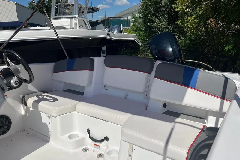 Slide: The Image of 2022 Tahoe T18 boat interior with cushioned seating and steering wheel. - 7