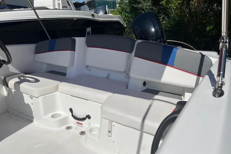 Slide: The Image of 2022 Tahoe T18 boat interior with white and gray seating, featuring blue and red accents. - 8