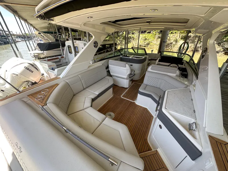 Slide: The Image of 2023 Sea Ray SLX 310 OB luxury boat interior with spacious seating and modern amenities. - 1