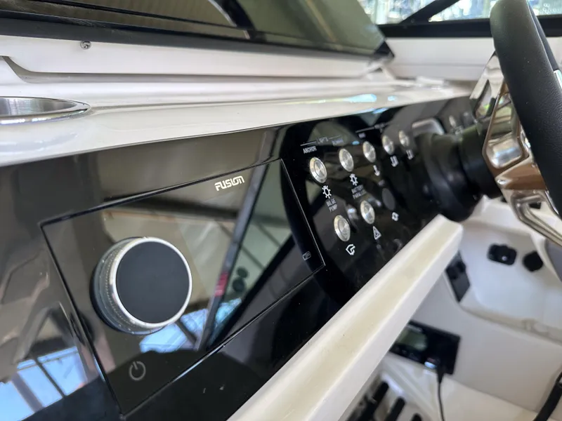 Slide: The Image of Close-up of the 2023 Sea Ray SLX 310 OB dashboard and control panel. - 10