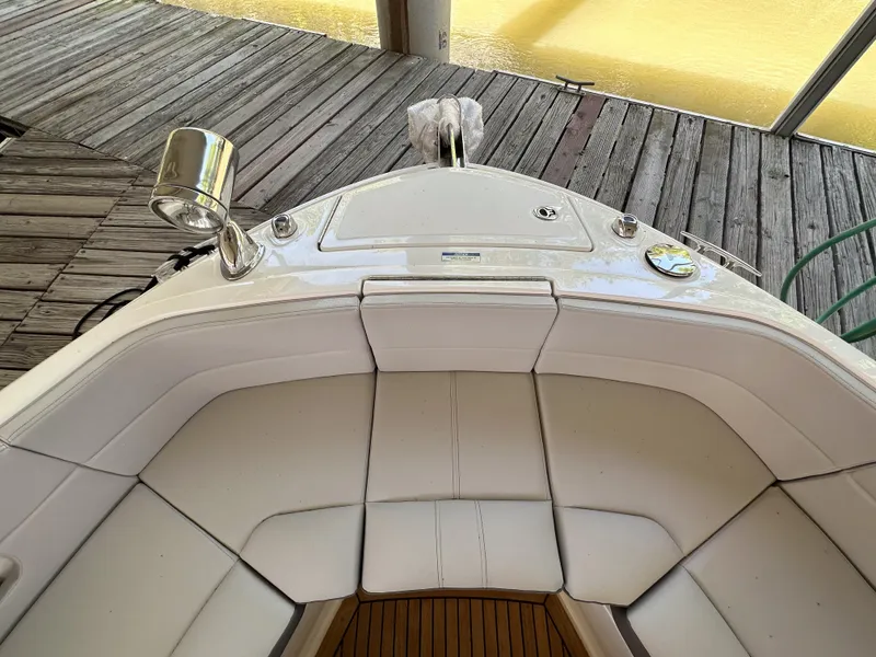 Slide: The Image of 2023 Sea Ray SLX 310 OB boat bow seating area with white upholstery. - 16