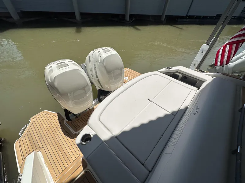 Slide: The Image of 2023 Sea Ray SLX 310 OB boat with twin outboard engines and spacious deck. - 2