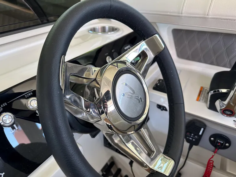Slide: The Image of Steering wheel of 2023 Sea Ray SLX 310 OB boat with modern controls. - 8
