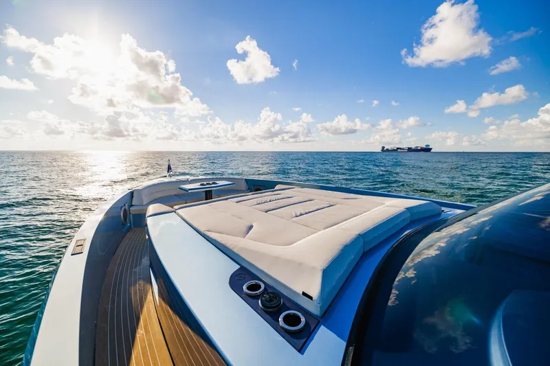 Slide: The Image of Luxurious 2019 Vanquish Yachts VQ58 on open sea under clear blue sky. - 11