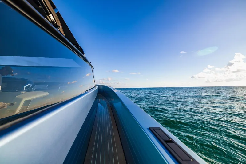 Slide: The Image of 2019 Vanquish Yachts VQ58 cruising on open sea under clear blue sky. - 12