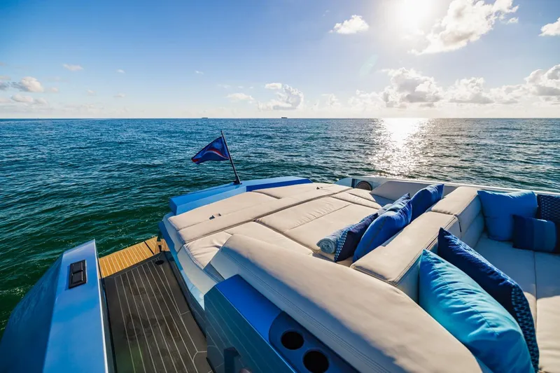 Slide: The Image of Luxurious 2019 Vanquish Yachts VQ58 on open sea with sunlit deck and cushions. - 15