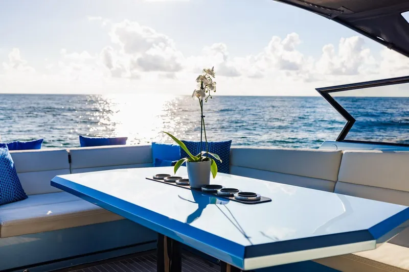 Slide: The Image of Luxurious 2019 Vanquish Yachts VQ58 deck with ocean view and elegant table setting. - 17