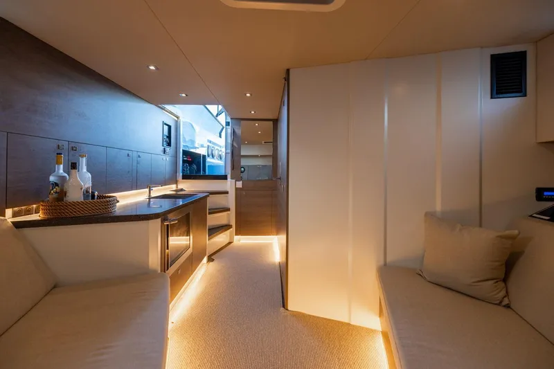 Slide: The Image of Luxurious interior of 2019 Vanquish Yachts VQ58 with modern kitchen and seating area. - 20