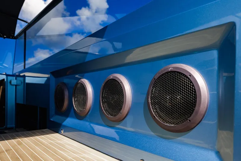 Slide: The Image of Close-up of 2019 Vanquish Yachts VQ58 speakers on a sleek blue exterior. - 26