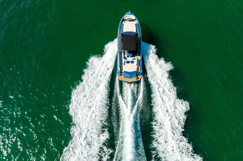 Slide: The Image of Aerial view of 2019 Vanquish Yachts VQ58 cruising on vibrant green water. - 30