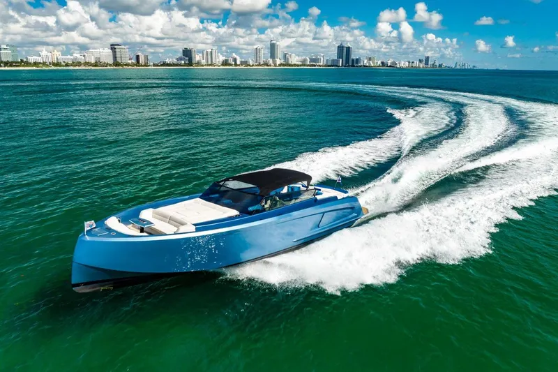 Slide: The Image of 2019 Vanquish Yachts VQ58 cruising on blue ocean near city skyline. - 31