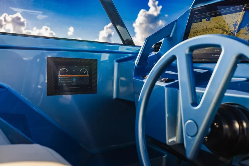 Slide: The Image of Cockpit of 2019 Vanquish Yachts VQ58 with modern navigation displays and steering wheel. - 32