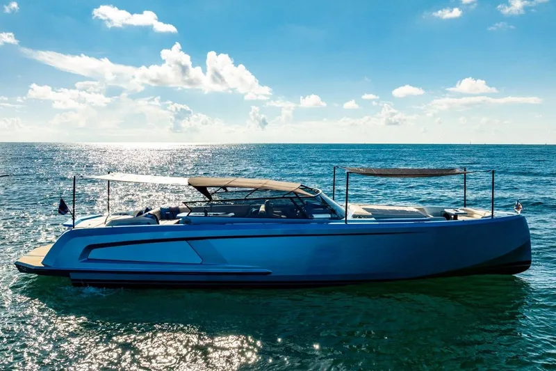 Slide: The Image of 2019 Vanquish Yachts VQ58 luxury yacht cruising on a sunny ocean. - 33