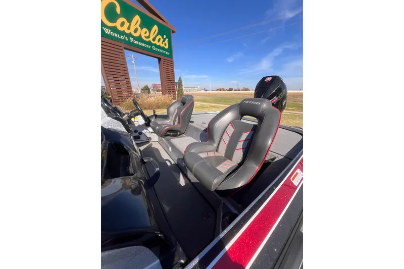Slide: The Image of 2019 Nitro Z19 Pro boat seats near Cabela's sign under clear blue sky. - 10