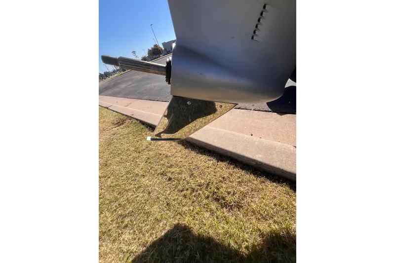 Slide: The Image of Close-up of a 2019 Nitro Z19 Pro boat motor on grass near pavement. - 12