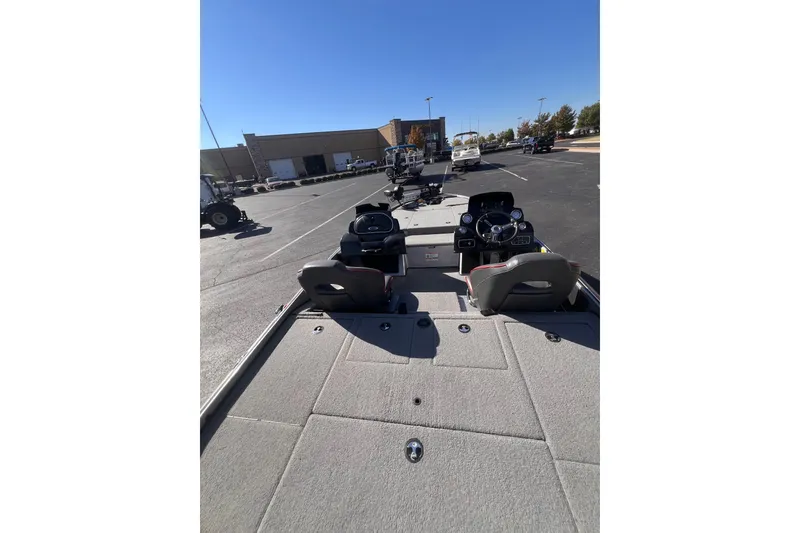 Slide: The Image of 2019 Nitro Z19 Pro boat interior in parking lot, showcasing steering console and seating. - 4