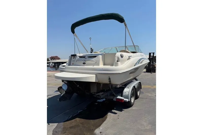 Slide: The Image of 2002 Sea Ray 210 Sundeck boat on trailer, rear view with canopy. - 1