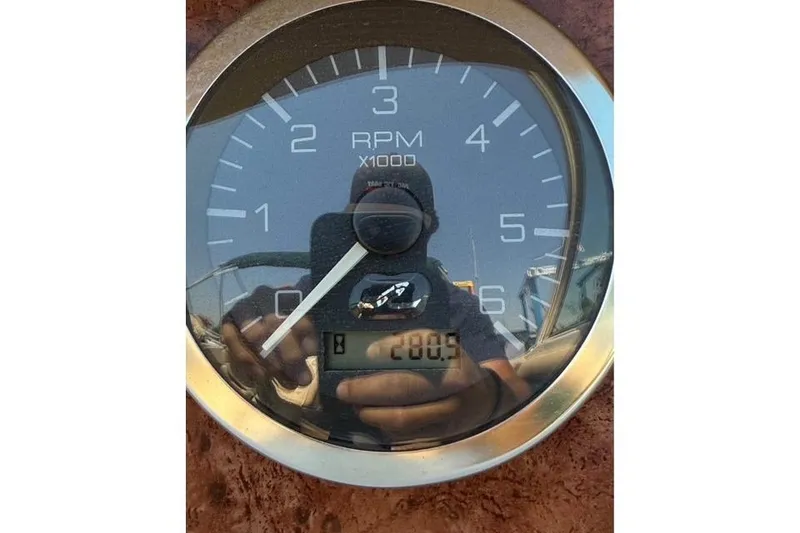 Slide: The Image of Close-up of a Sea Ray 210 Sundeck 2002 RPM gauge showing 200.9 hours. - 12