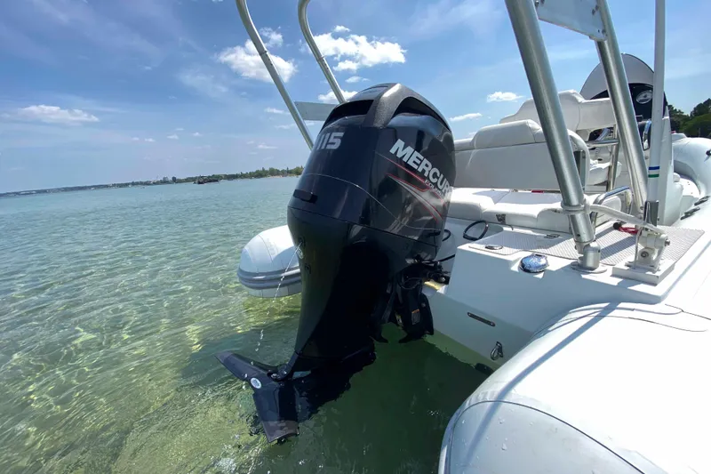 Slide: The Image of 2013 Mercury Inflatables M570 boat with outboard motor on clear water. - 6