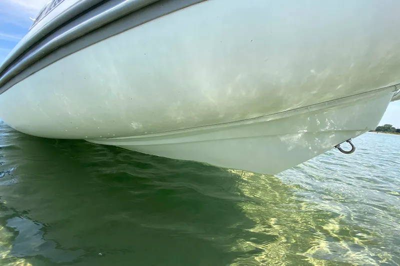 Slide: The Image of 2013 Mercury Inflatables M570 boat hull in clear water, showcasing sleek design. - 9