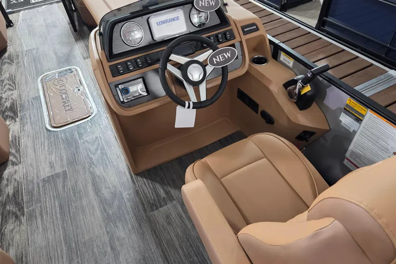 Slide: The Image of 2026 Godfrey SWEETWATER 2486 SFL boat interior with tan seating and modern dashboard. - 5