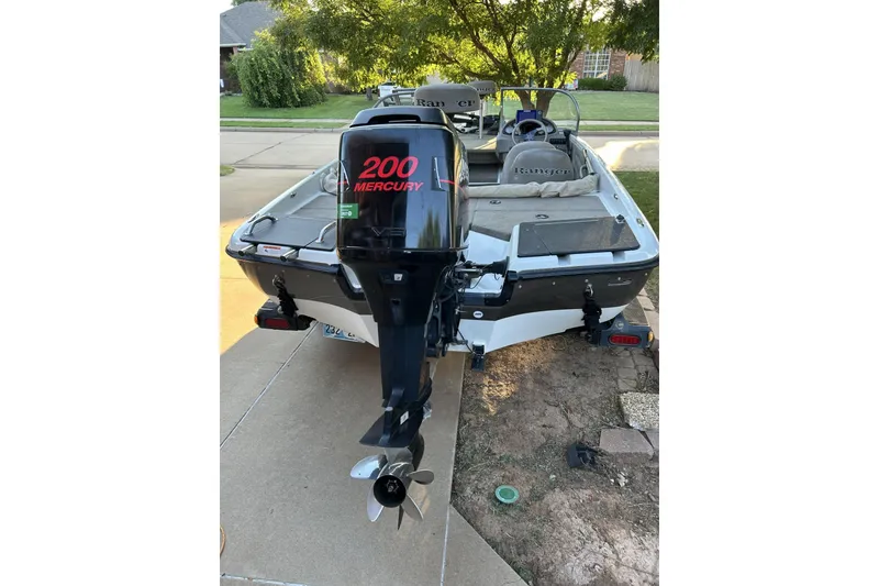 Slide: The Image of 2004 Ranger 190 VS boat with Mercury 200 engine, parked on driveway. - 3